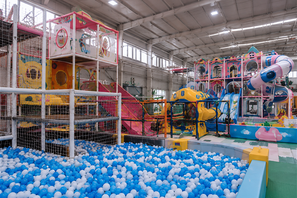 Indoor playground structures assembled in Toplay's factory staging area before packing.